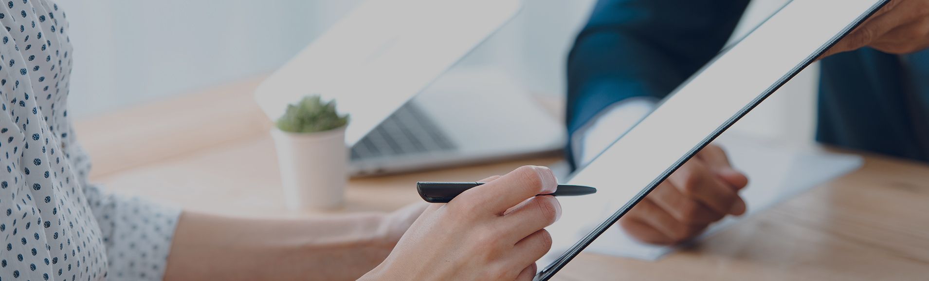 Person Looking over DUI Legal Papers with pen in right hand